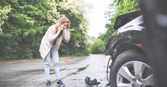 woman on phone after car accident