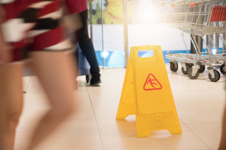 Sign showing warning of caution wet floor at grocery store